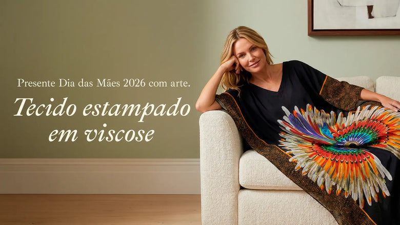 Mulher sentada no sofá vestindo presente Scarf Me de Dia das Mães 2026 feito de tecido estampado em viscose, celebrando a data com arte e elegância.