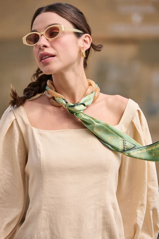Model with a green scarf around her neck